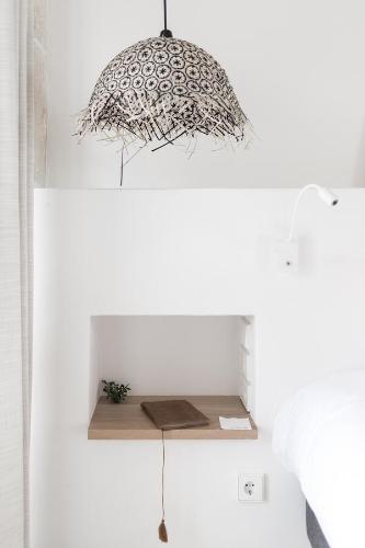 a pendant light hanging over a shelf in a room at Torre Vella Fontenille Menorca in Son Bou