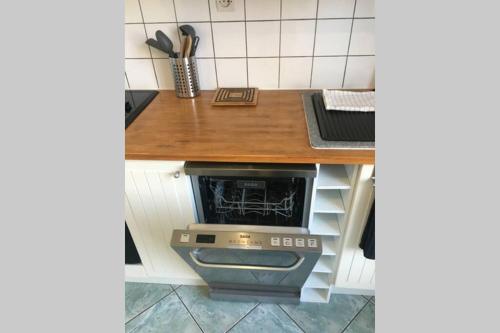 a kitchen with a counter with a stove in it at LES ÎLES - Parking, Balcon & PS4! in Annecy