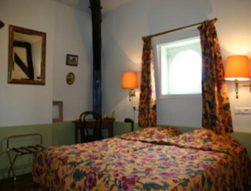 a bedroom with a bed and a window at Au Château Des Thermes in Saint-Amand-les-Eaux
