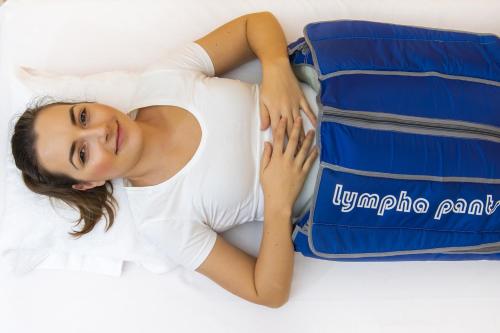 a young woman laying next to a suitcase at Savoy Spa & Kurhotel in Františkovy Lázně