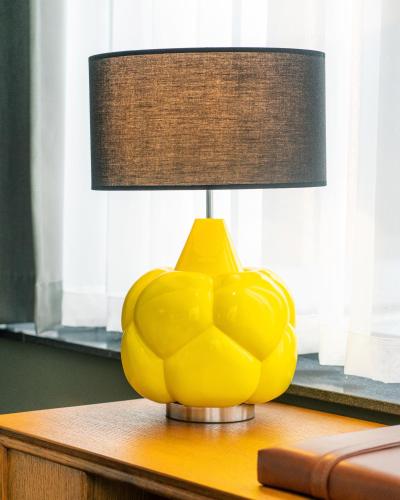 a yellow lamp sitting on top of a table at The Collector in The Hague