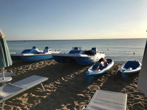 a group of boats parked on the beach at Villa Antonella in Villasimius