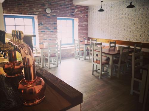 a restaurant with tables and chairs and a brick wall at Apartments Eibenthal in Eibenthal