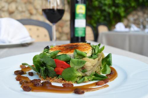 a plate of food with a salad on a table at Hotel Zuhayra in Zuheros