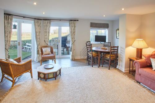 a living room with a couch and a table at Host & Stay - Tithe Cottage in Harrogate