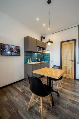 a dining room with a wooden table and chairs at Secret Apartments in Kyiv