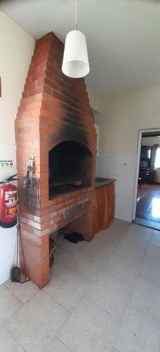 a brick fireplace in a living room with a light at Casa S. Félix in Arcos