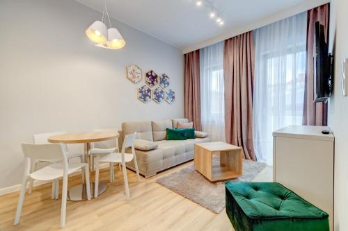 a living room with a table and a couch at Apartamenty Rondo in Świnoujście