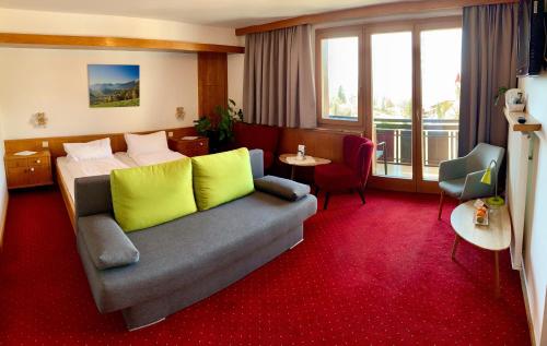 a hotel room with a couch with yellow pillows at Haus Lukas in Seefeld in Tirol