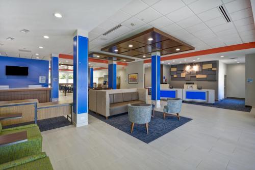 a lobby of a hospital with blue columns and chairs at Holiday Inn Express & Suites - Houston NASA - Boardwalk Area by IHG in Seabrook