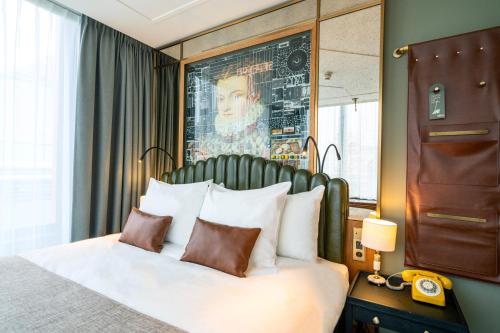 a hotel room with a bed and a picture on the wall at The Collector in The Hague
