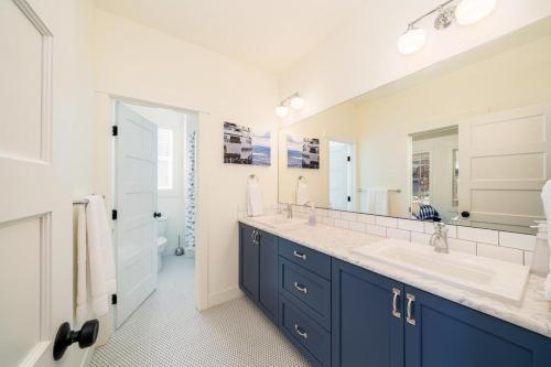 a bathroom with two sinks and a large mirror at Best.Day.Ever. #58 in Chelan
