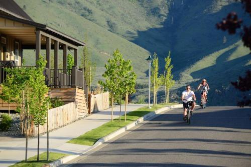 two people riding a bike down a street at Beachy Keen #56 in Chelan