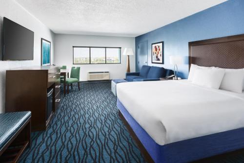 a hotel room with a large bed and a desk at Coco Key Hotel & Water Park Resort in Orlando