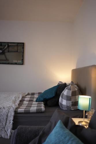 a bedroom with a bed and a table with a lamp at Kuschelnest Michelstadt in Michelstadt