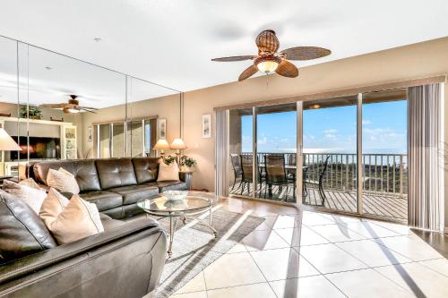a living room with a couch and a ceiling fan at Oceanside Condos in Clearwater Beach