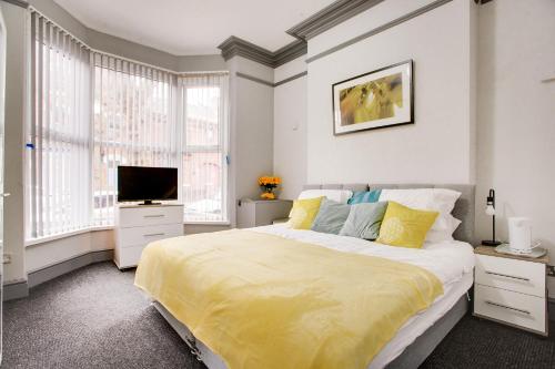 a bedroom with a large bed and a television at Wray And Whyte House in Birmingham