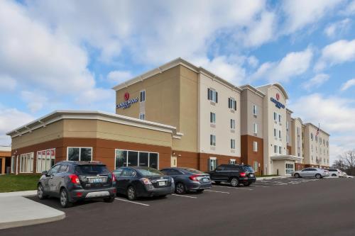 a hotel with cars parked in a parking lot at Candlewood Suites Louisville - NE Downtown Area by IHG in Louisville