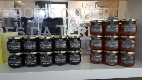 a group of jars of honey on a shelf at Casa Valxisto in Penafiel