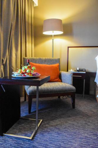 a room with a couch and a table with a plate of fruit on it at Cresta Mahalapye Hotel in Mahalapye