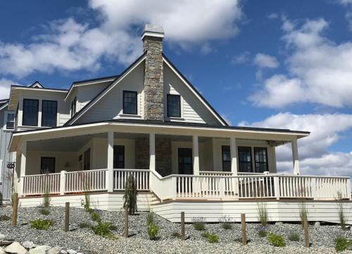 a large white house with a porch at Brass Monkey #74 in Chelan