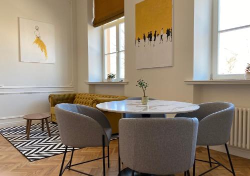 a living room with a table and chairs at Glamour apartment in Liepāja