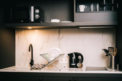 a kitchen with a counter top with a sink at Getaway Studios Gent in Ghent
