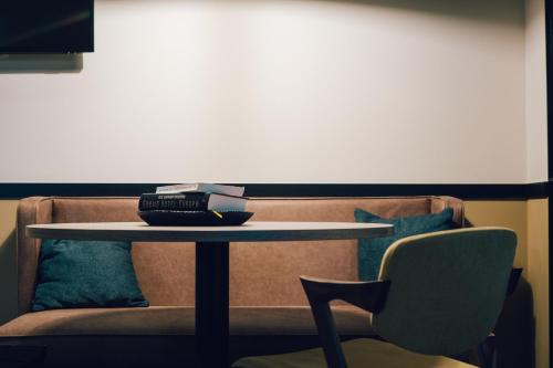 a table and a couch with a table and a chair at Getaway Studios Gent in Ghent