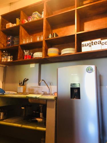 a kitchen with a stainless steel refrigerator in front of a counter at Refugio del Cielo # in Sayulita