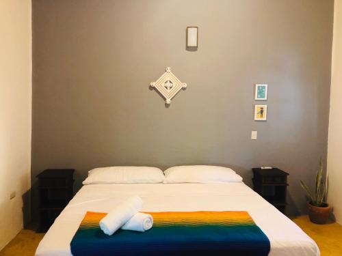 a bed with a colorful blanket on top of it at Refugio del Cielo # in Sayulita