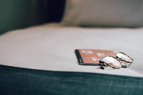 a pair of watches sitting on top of a bed at Getaway Studios Gent in Ghent