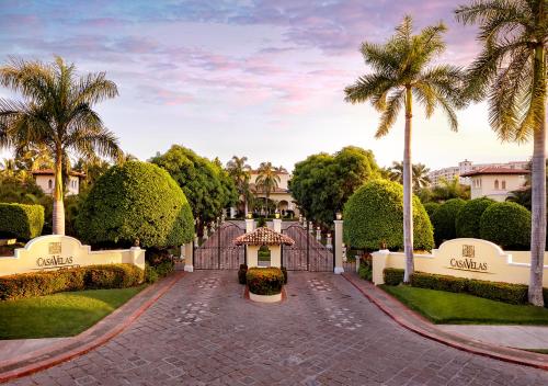 a driveway leading to a villa with palm trees at Casa Velas Adults Only All Inclusive in Puerto Vallarta