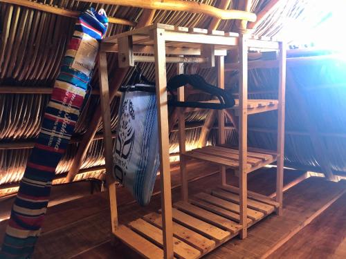 a wooden shelf with a surfboard in a room at Refugio del Cielo # in Sayulita