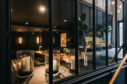 a room with a window with candles on a table at Getaway Studios Gent in Ghent