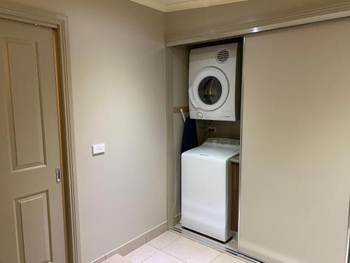 a laundry room with a washer and a washing machine at The Lodges Two in Halls Gap