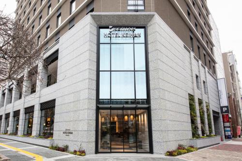 a building with a large window on a street at Hotel Keihan Nagoya in Nagoya