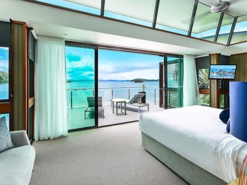 a bedroom with a bed and a view of the ocean at Yacht Club Villas on Hamilton Island by HIHA in Hamilton Island