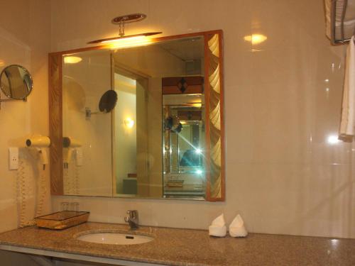 a bathroom with a sink and a mirror at Semec Hotel Nghi Son in Tĩnh Gia