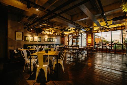 a restaurant with tables and chairs in a room at Rosa Malacca in Melaka