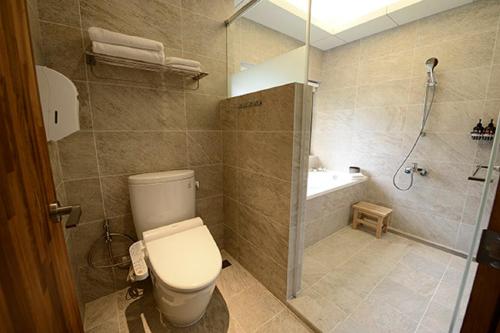 ein Bad mit einem WC und einer Dusche in der Unterkunft 鄉道茶屋 Country Road B&B in Toucheng