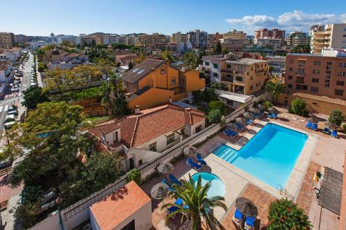 an aerial view of a building with a swimming pool at Apartamentos Embajador in Fuengirola