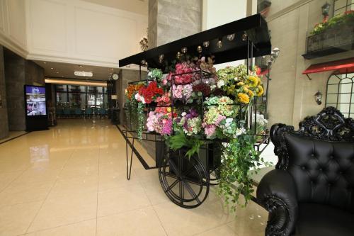 a bunch of flowers on display in a lobby at Ashley Sabang Jakarta in Jakarta