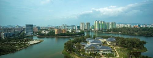 an aerial view of a river with buildings and houses at HUALUXE Yangjiang City Center in Yangjiang
