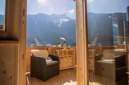 a balcony with two chairs and a view of a mountain at Luxury Naturperle Haus Alpenprinzessin helles Holzhaus zentral , modern & großräumig in Neustift im Stubaital