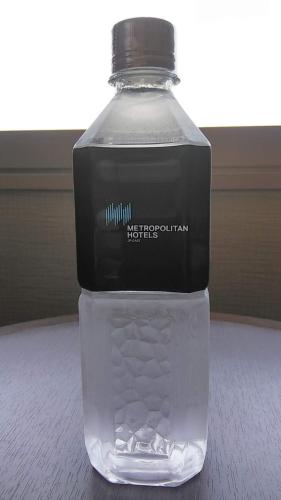 a bottle of water sitting on a table at Hotel Metropolitan Nagano in Nagano