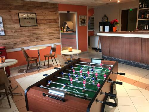 a pool table in the middle of a restaurant at Hotel Les Chênes in Sisteron