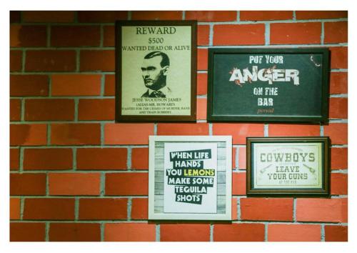 a group of signs on a brick wall at Poppys Hotel Madurai in Madurai