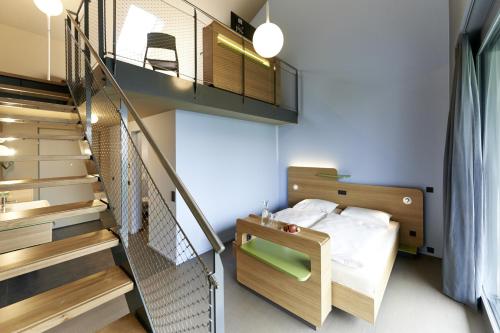 a bedroom with a bunk bed and a staircase at Hotel mein inselglück in Reichenau