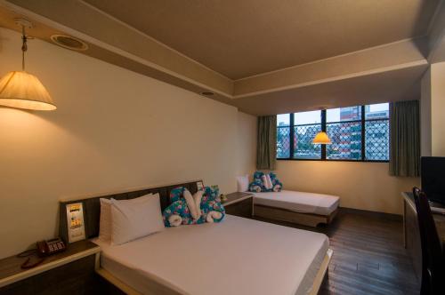 Ένα ή περισσότερα κρεβάτια σε δωμάτιο στο Dahua Hotel