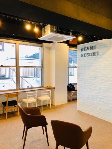 a meeting room with chairs and a sign that reads arminantinant at bnb+Atami Resort in Atami